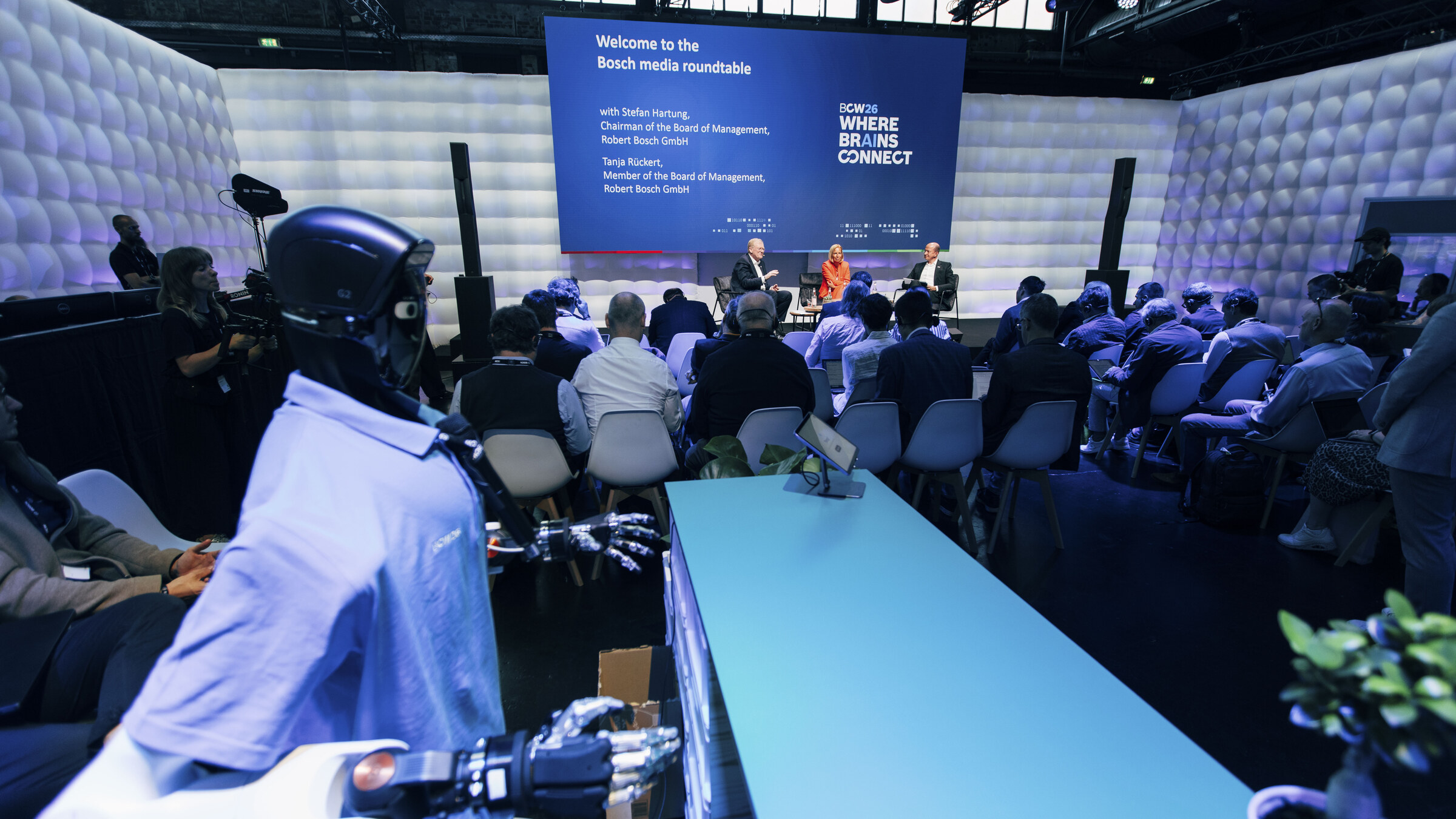 A humanoid robot beside a refreshment trolley at Bosch Connected World 2026
