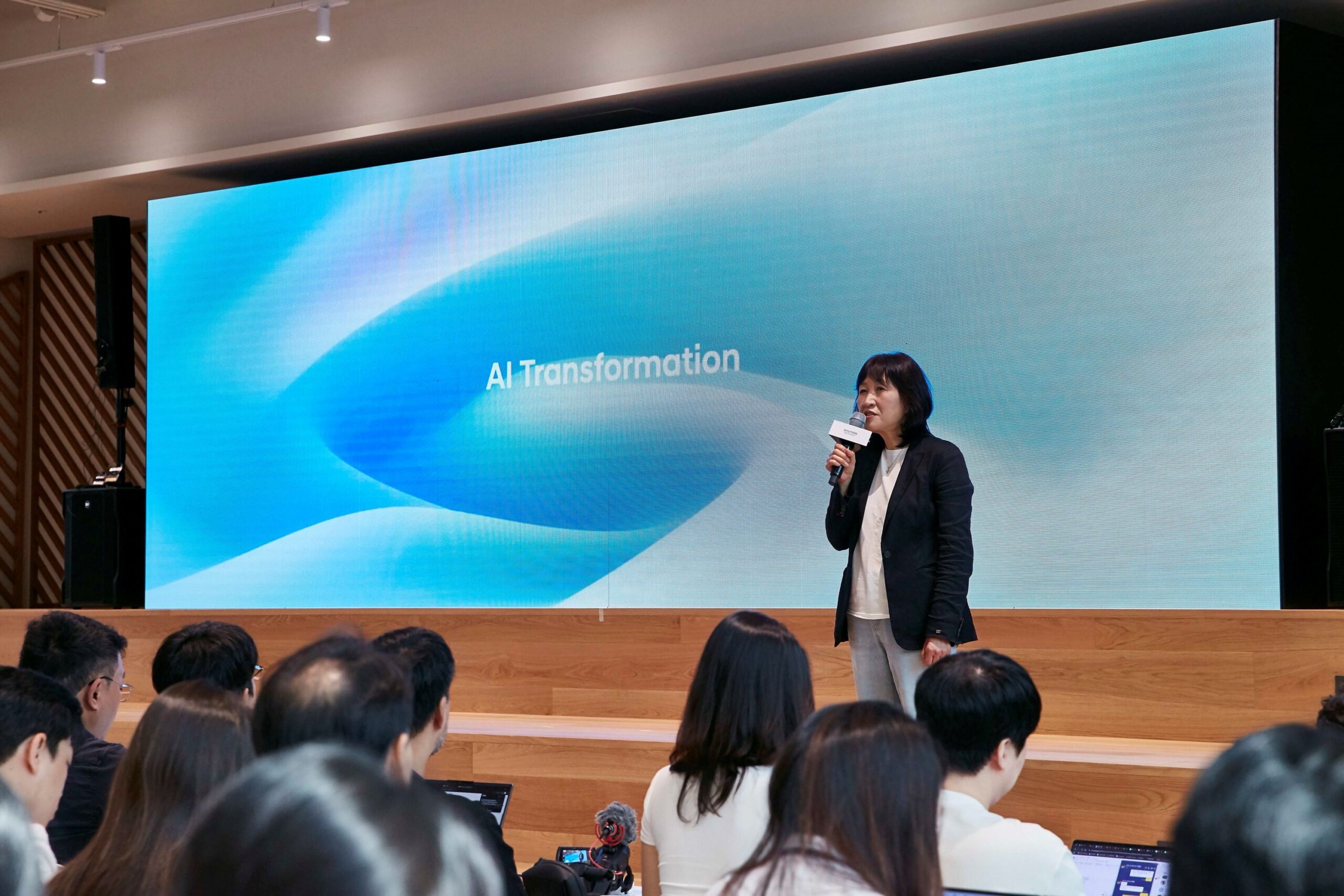 Eunsook Jin presents in front of an AI Transformation screen at Hyundai Motor Group’s August 2026 showcase.