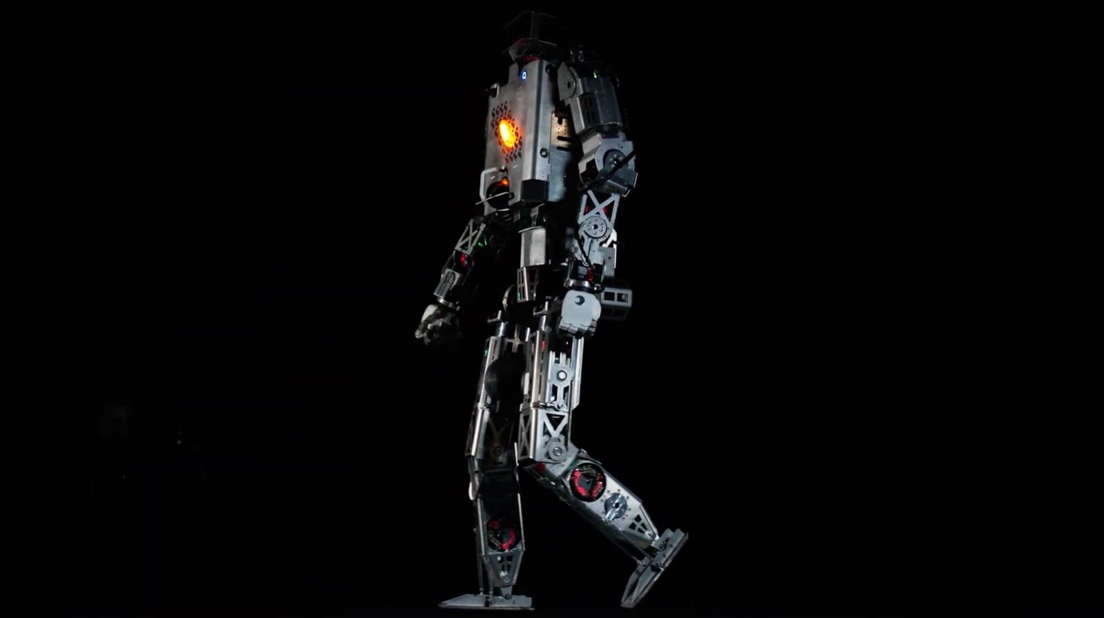 Minerva’s Roger humanoid prototype in profile against a black background, with one leg raised.